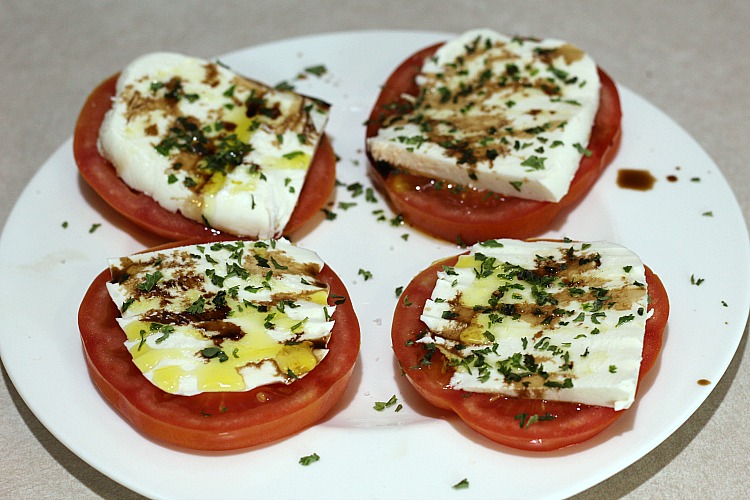 4 tomato Caprese Appetizer on a white plate