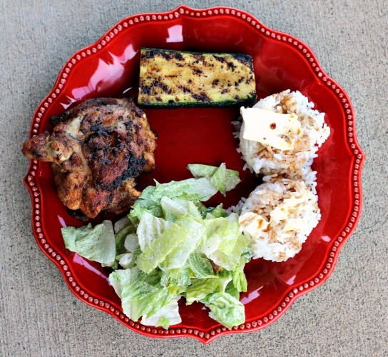 Grilled chicken thighs served with Grilled Zucchini, white rice, cesar salad