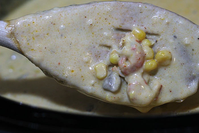 Crawfish chowder cooked on a spoon with crawfish and corn 