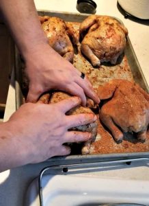 Cornish Game Hens Being Rubbed With Rub
