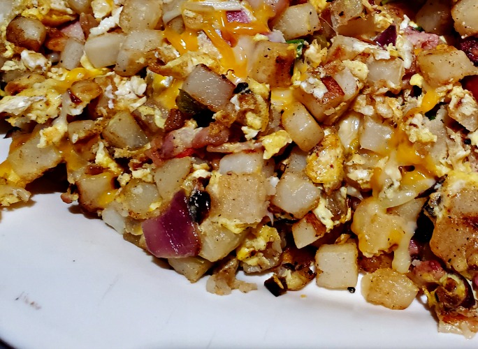 Blackstone Breakfast Hash cooked on white plate 
