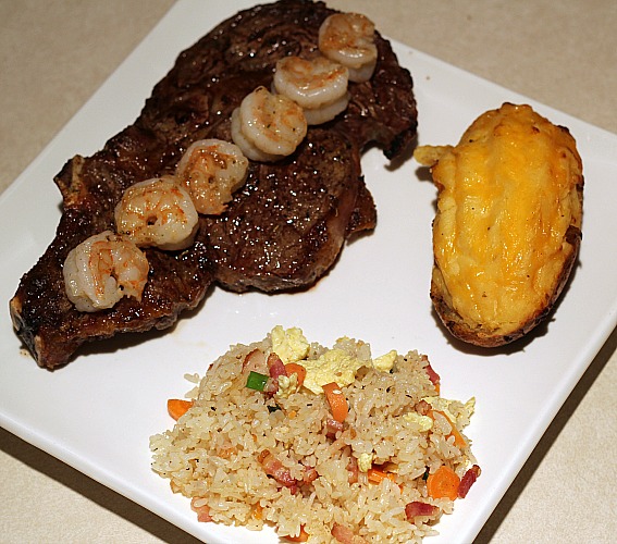 Hibachi Fried Rice Served with steak and shrimp, with a twice baked potato on the side