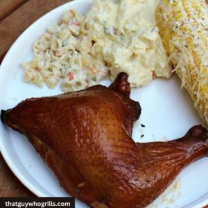 Smoked Coca-Cola Chicken Leg Quarters served with pasta salad, potato salad and Mexican street corn on the cob