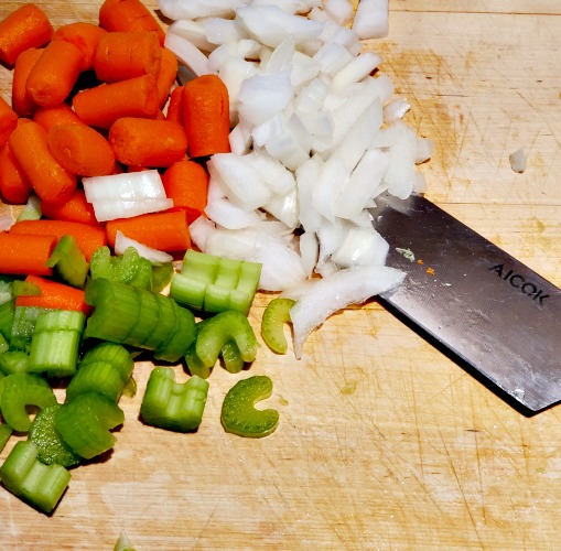 Chopped white onion, Chopped celery, and chopped baby carrots for smoked chicken noodle soup