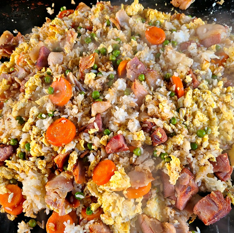 Ham Fried Rice On Blackstone Griddle is the perfect way to use up leftover holiday ham! Add in bacon for more flavor, and an easy leftover dinner to make!