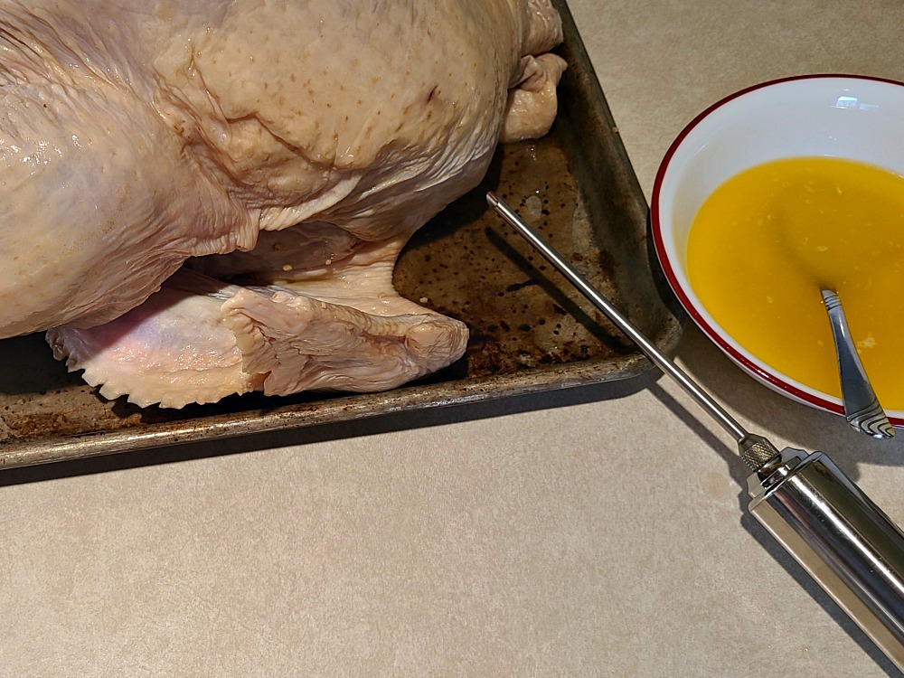 Metal Injector Next To Turkey To Inject Liquid Butter From Bowl 
