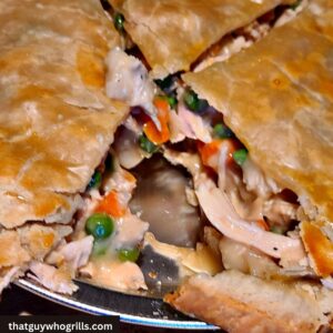 Smoked Chicken Pot pie in pie tin with a slice missing