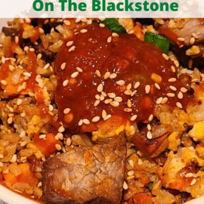 Teriyaki Steak Fried Rice On The Blackstone is the perfect weeknight dinner! Easy to make and the marinade makes for amazing flavor on the steak! Make on the Blackstone to keep the kitchen clean and quick clean up! Use frozen carrots and peas with a rice cooker for an easy dinner the whole family will eat! Cook this hibachi-style outside and look like a professional chef!