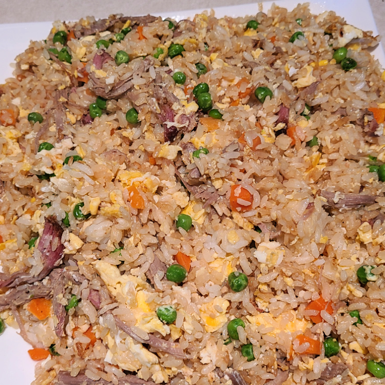This Shredded Pork Fried Rice Recipe On The Blackstone is perfect to make with leftover smoked pulled pork! The smoke flavor adds to the fried rice!  Fried rice is an easy weeknight dinner that is easy to make on the Blackstone griddle!  
