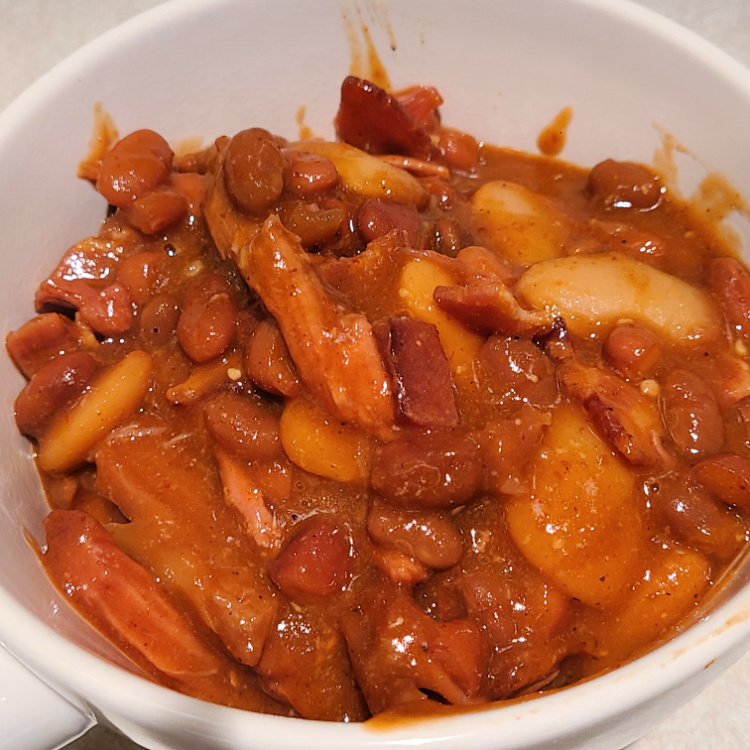 This Smoked Shredded Pork Baked Beans Recipe is the perfect side dish to use up leftover shredded pork! Plus it also makes a great lunch as well! Smoke these beans in a cast iron dutch oven to add more flavor to the beans as well! This is perfect to serve at a bbq or family get-together.