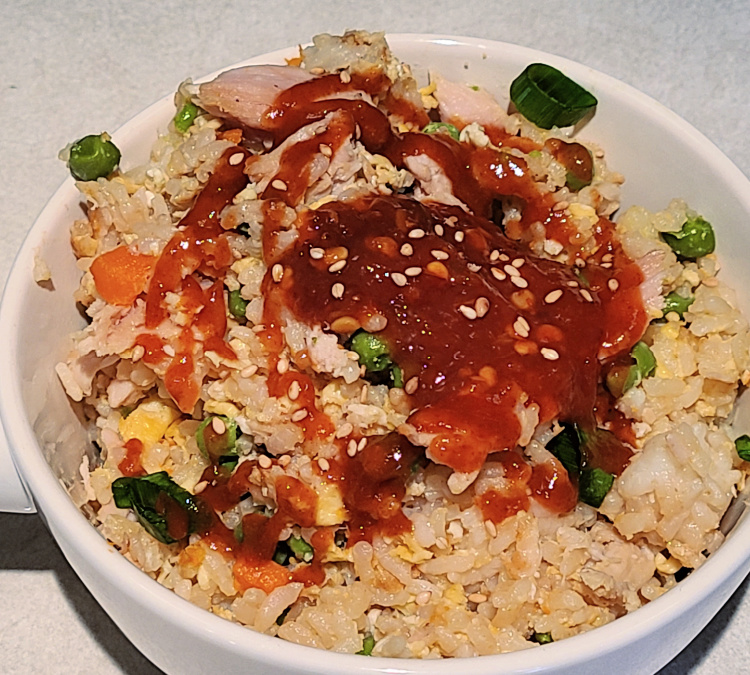 Smoked Turkey Fried Rice served with chili paste, siracha sauce, and sesame seeds. 