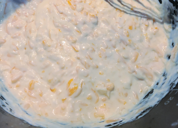 milk sauce for smoked mac and cheese mixed with shredded cheese