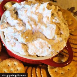 Smoked Salmon Dip Served in a red dish with ritz crackers around it