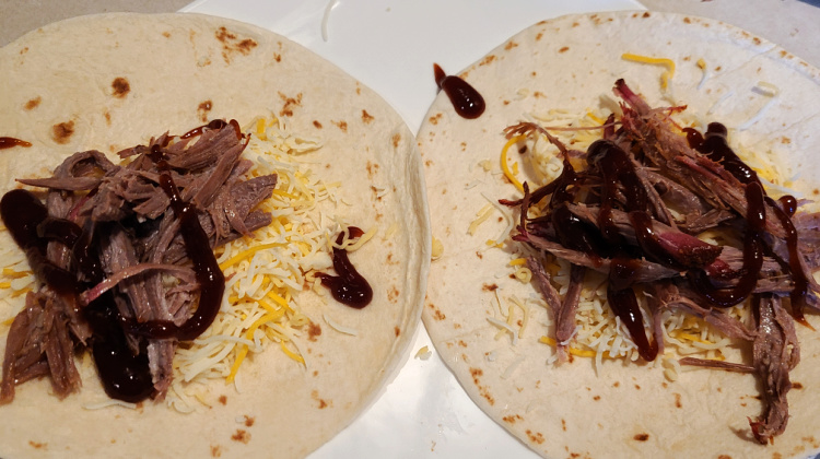 Flour tortilla with shredded brisket, shredded cheese and bbq sauce. 