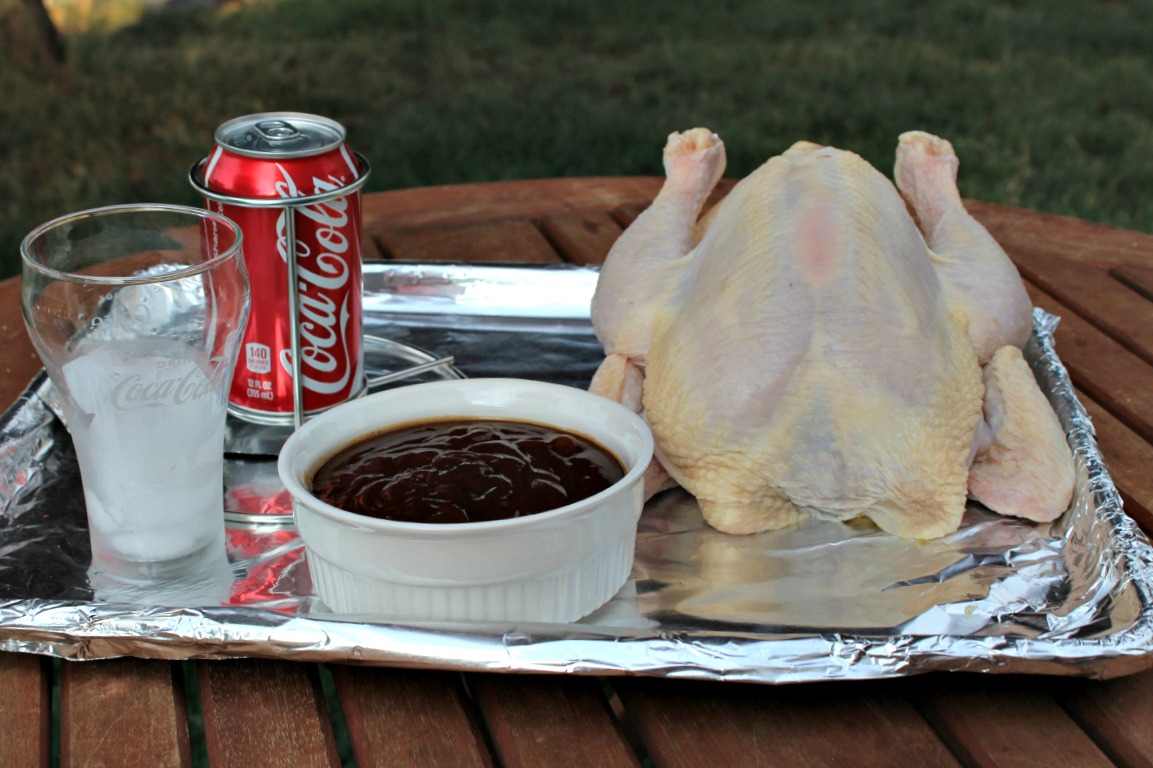 Coke Can Chicken on the grill ingredients on a tray 