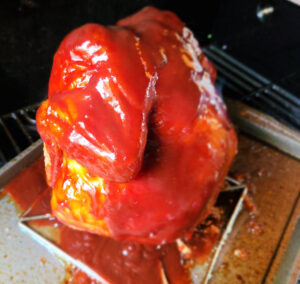 Coke Can Chicken On The Grill coated in bbq sauce
