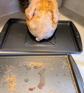 Coke Can Chicken on beer can holder on a cookie sheet