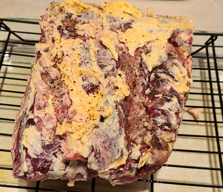 Prime Rib Rubbed With Butter And Rub On Baking Rack