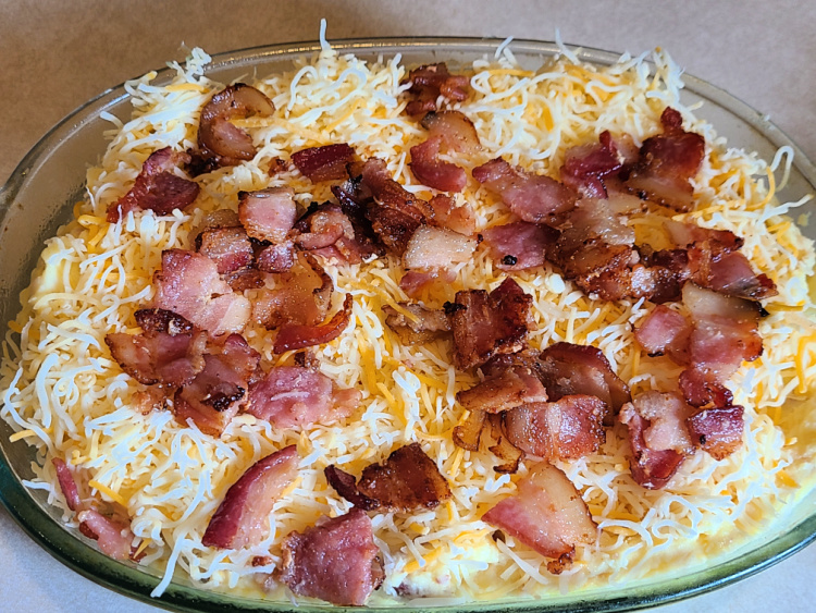 Smoked Loaded Cheesy Potatoes are easy to make and pair up with the main dish! Smoke low and slow for amazing flavor! The bacon combines with the cream cheese, butter, and cheese to add flavor! Smoke in a casserole pan for an easy smoked side dish to serve!