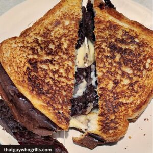 Prime Rib Grilled Cheese Served on a White Plate