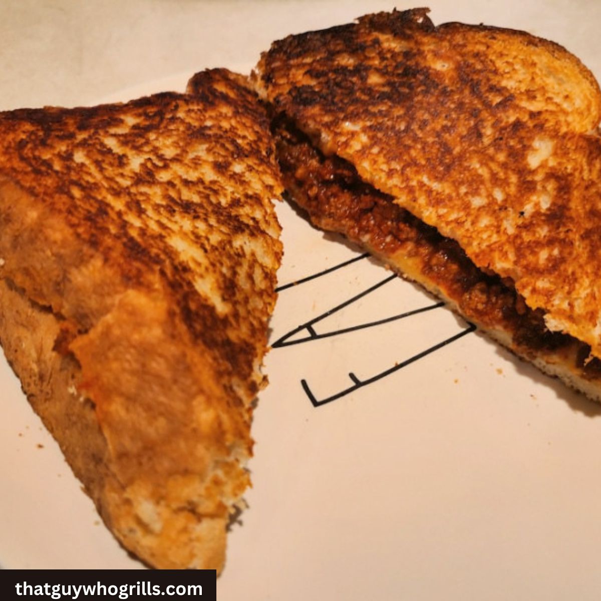 Sloppy Joe Grilled Cheese Sandwich Served On White Plate