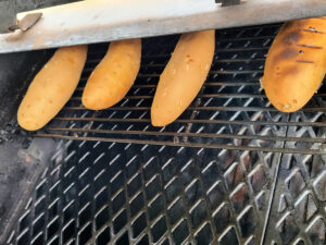 sweet potatoes smoking on Pit Boss Grill