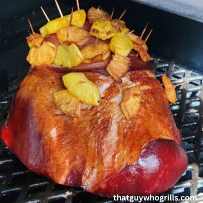 Ham Smoking on a pitboss grill with pineapple stuck on it