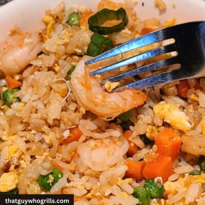 Blackstone Shrimp Fried Rice served in a white bowl with a fork