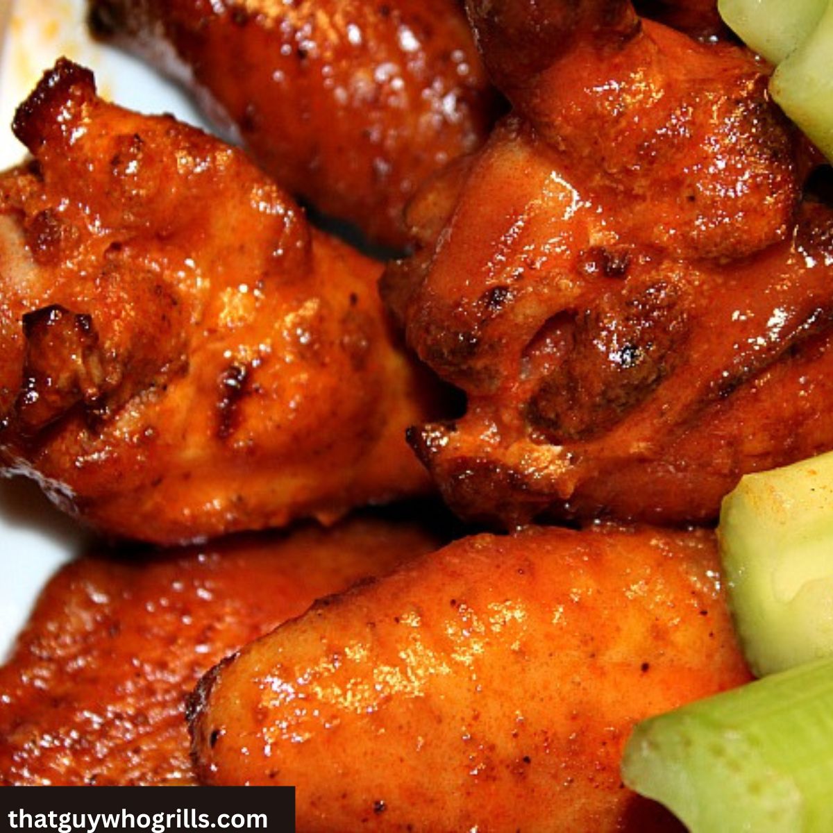 Sauced spicy smoked chicken wings with celery