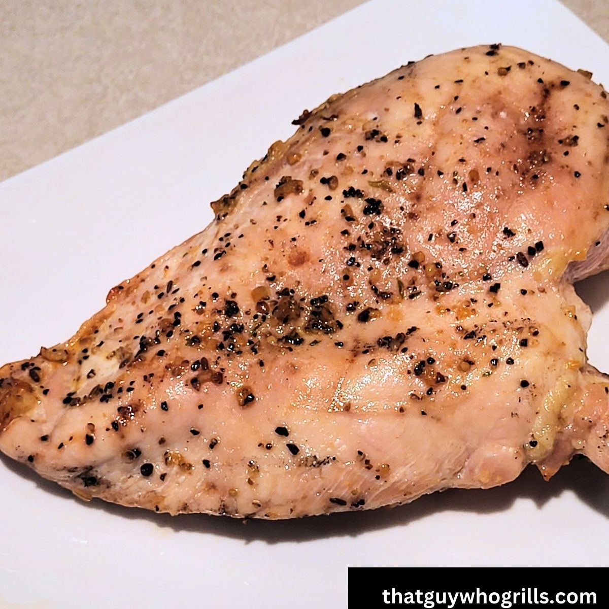 Grilled Chicken Breasts Served on a white plate
