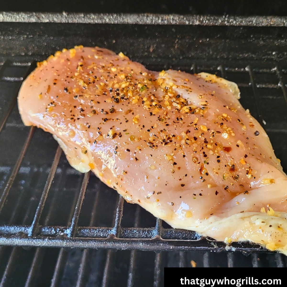 Seasoned Chicken breasts on a gas grill before cooking