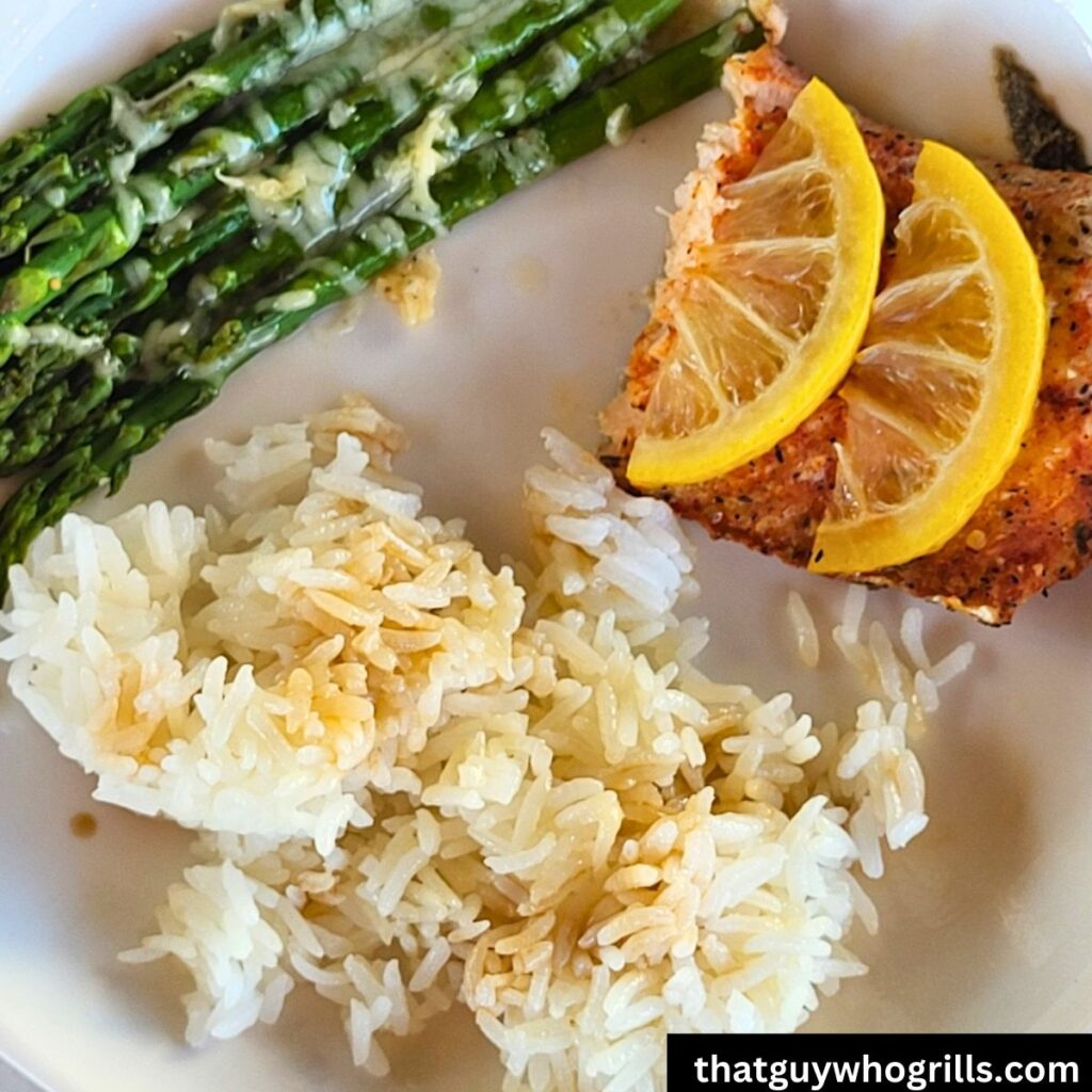 Grilled Salmon in foil packet served with white rice and cheesy asparagus