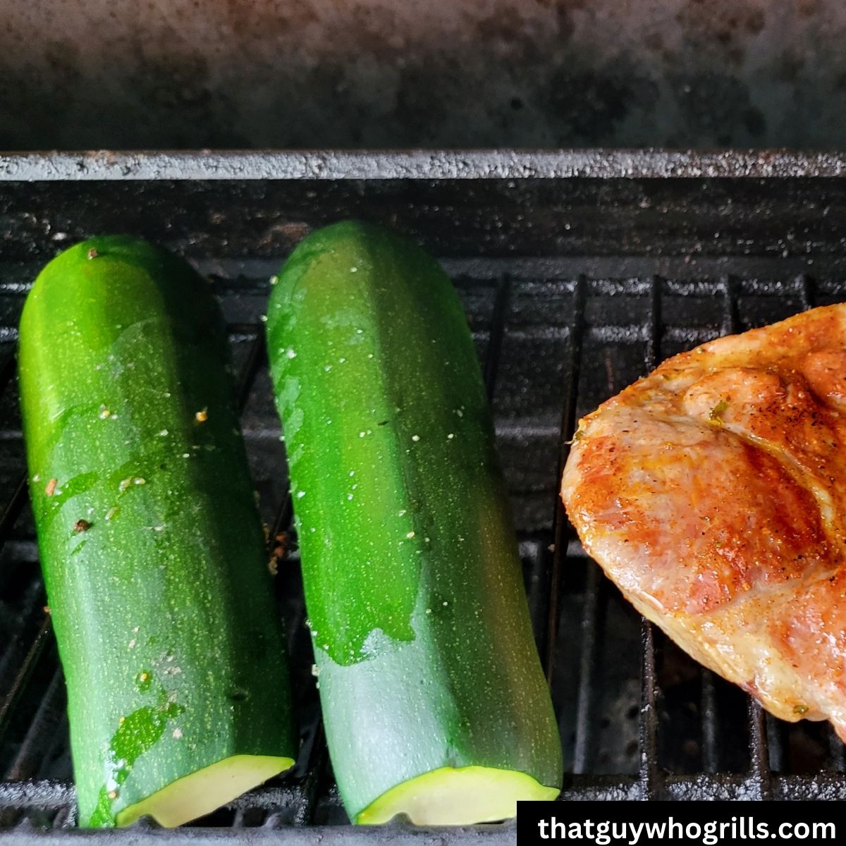 Grilled Zucchini cooking on grill rack with pork steak
