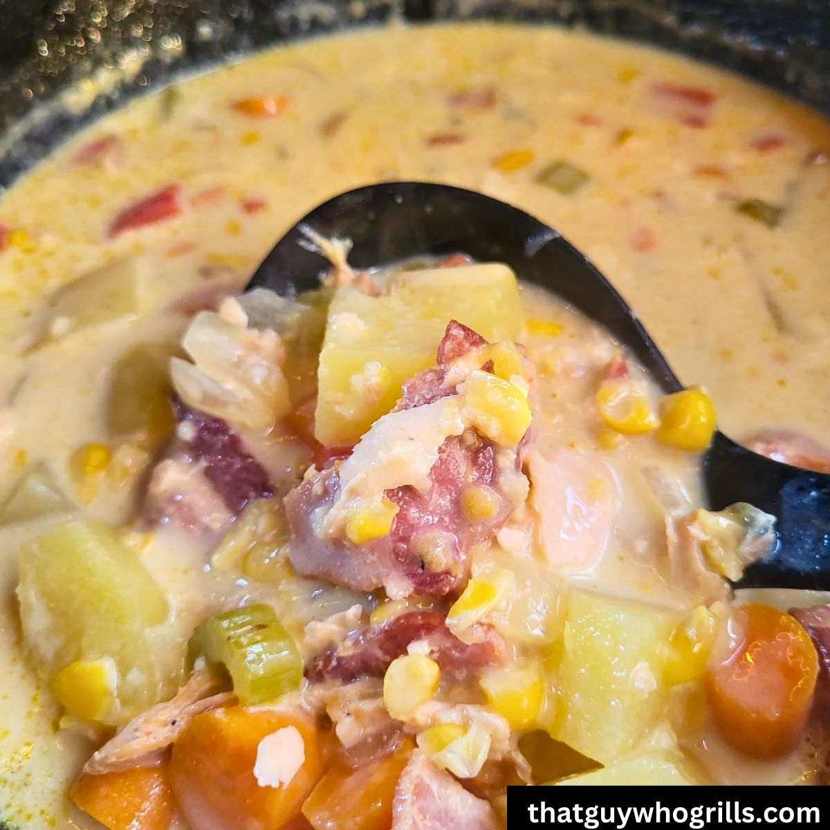 Ladle scooping out salmon chowder out of dutch oven